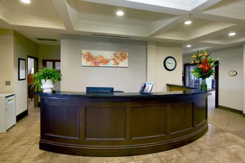Lobby with a curved wooden reception desk