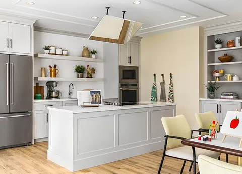 Craft kitchen with an island, appliances and an art table.