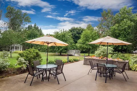 Patio with umbrella tables, chairs and flower beds