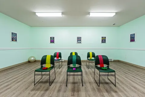 Exercise room with chairs, resistance bands and small hand weights