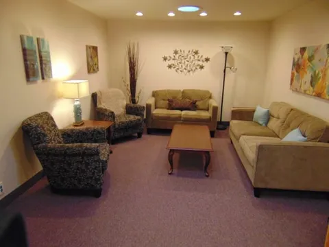 Suite lounge with sofas, armchairs, floor lamps and a coffee table.