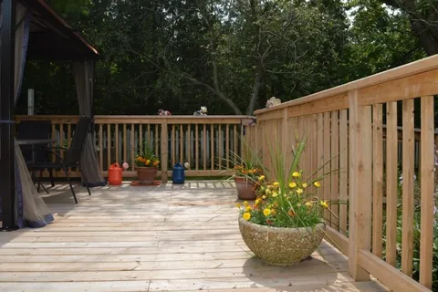 Wooden deck with a flower planter beside the railing