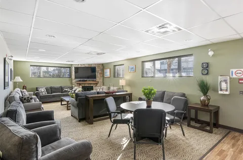 Sitting area with grey sofas, armchairs and a central table