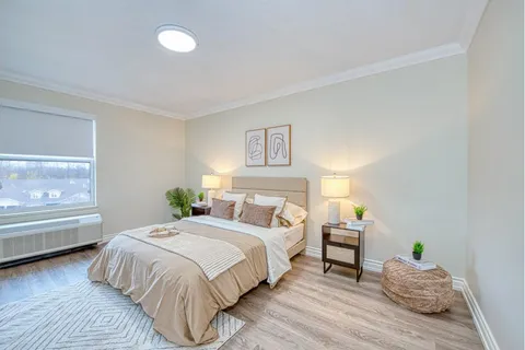 Bedroom with a double bed, bedside cabinets and lamps.