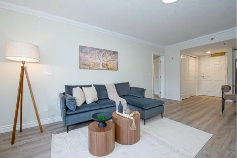 Suite living area with a sofa, chaise longue and side tables.