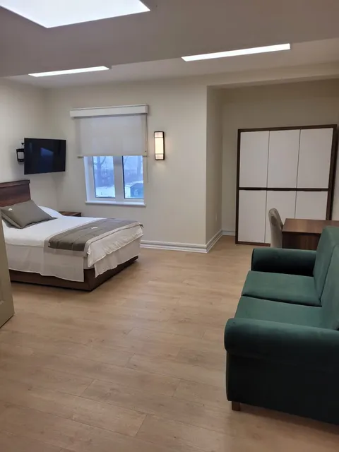 Studio suite with a bed, sofa and wardrobe.