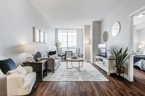 Sitting area with a sofa, armchair, dining table and television