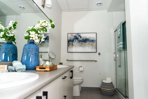 Bathroom with a vanity, shower and toilet.