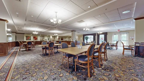 Dining room with tables, blue chairs and chandeliers