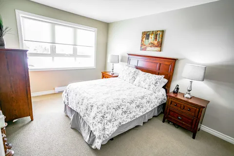 Bedroom with a double bed, wooden bedside tables and a large window