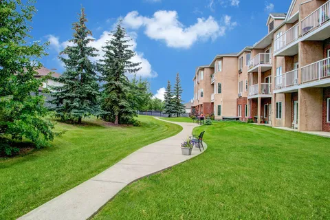 Walking path across a lawn beside the residence building.