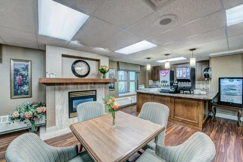 Bistro with tables, chairs, a counter and a fireplace.