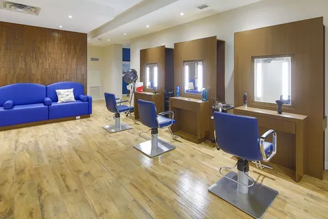Salon with styling chairs, mirrors and washbasins.