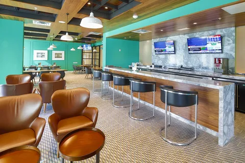 Pub with a wooden bar and stools.