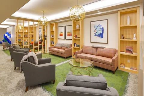 Library lounge with bookcases, sofas and armchairs.