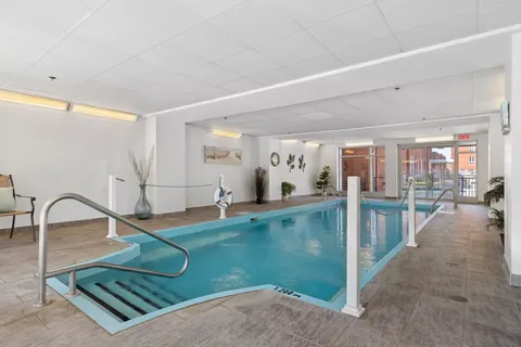 Indoor pool with entry steps and large windows