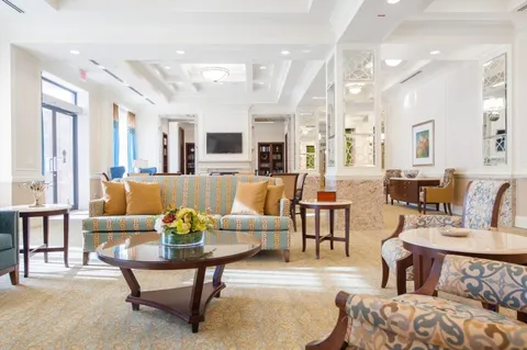 Room with sofas, armchairs, a fireplace and a coffered ceiling