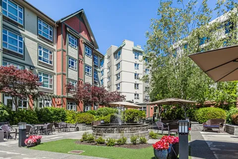Landscaped courtyard with paths, lawn and the residence behind