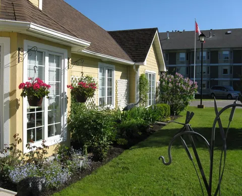 Bungalow windows and lawn beside the main residence.