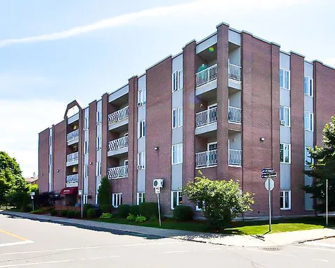 Brick residence with balconies beside a street