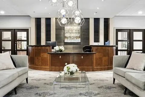 Lobby sofas and coffee table in front of a reception desk.