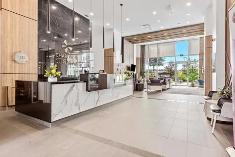 Lobby with reception desk, seating and large windows