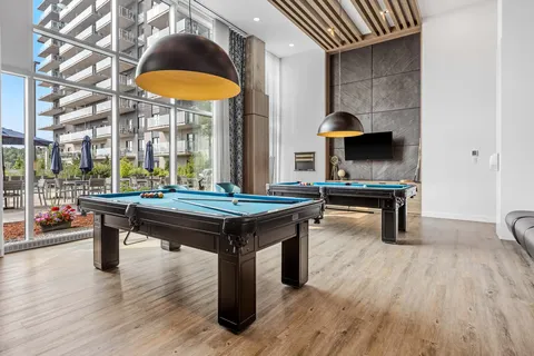 Games room with pool tables and large pendant lights