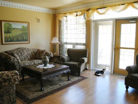 Sitting area with patterned seating and a glass exterior door.
