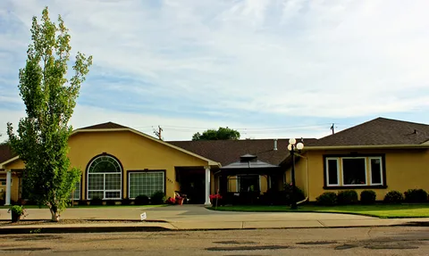 Single-storey residence with a covered entrance and front lawn.