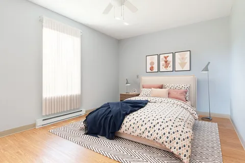 Bedroom with a double bed, bedside tables and lamps.