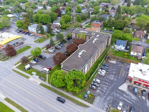 Aerial view of the residence building, grounds and parking area.