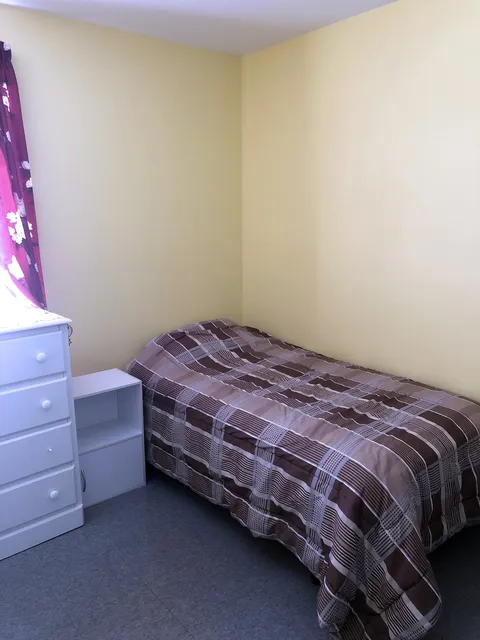 Single bedroom with a bed and storage drawers.