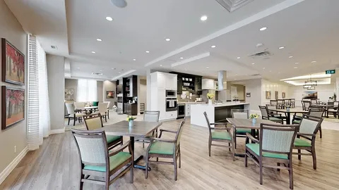 Tables and chairs beside an open kitchen and serving counter