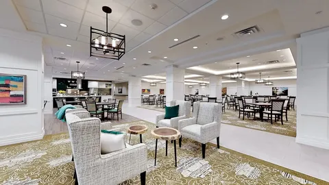 Upholstered armchairs and tables in an open room