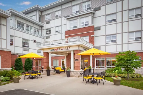 Residence building and courtyard with yellow umbrellas and tables