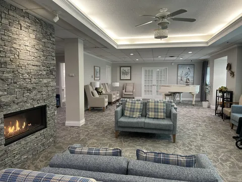 Fireside lounge with sofas, stone fireplace and coffered ceiling.