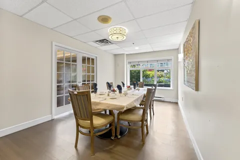 Private dining room with a round table and upholstered chairs.