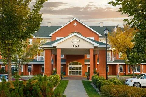 Front exterior with entrance canopy between brick columns.