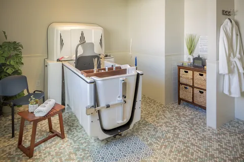 Bathing room with an accessible tub and seating.
