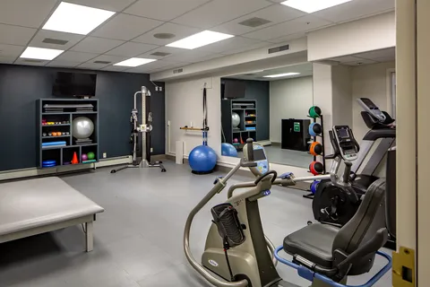 Fitness room with exercise bikes and strength equipment.