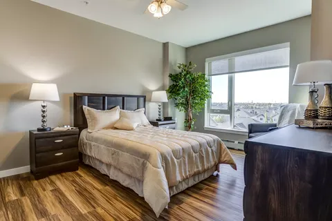 Bedroom with a double bed, bedside tables, lamps and a window