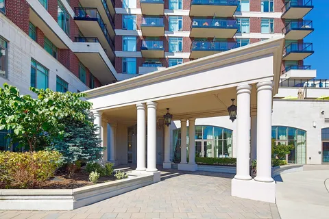 Covered entrance supported by white columns