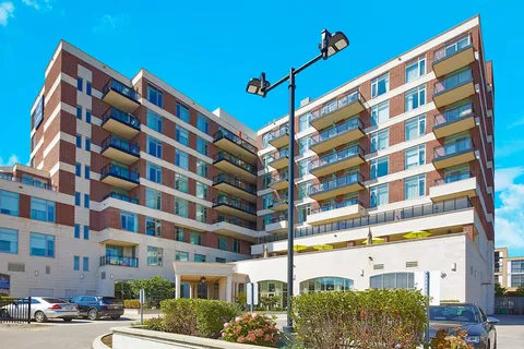 Residence exterior with balconies and landscaped entrance beds
