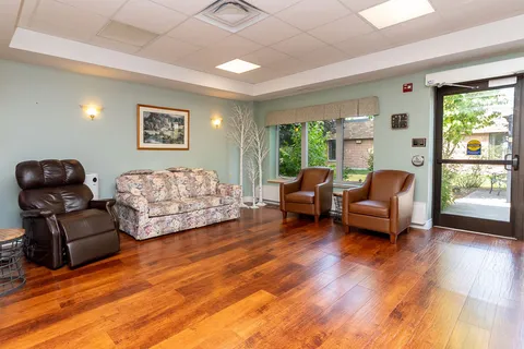 Lounge with a sofa, armchairs and glass doors.