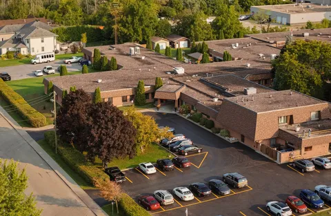 Aerial view of the care centre buildings, parking areas and neighbouring streets.