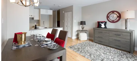 Suite dining table beside kitchen cabinets and a sideboard