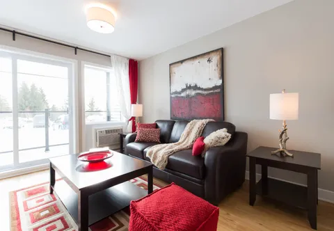 Suite living room with a sofa beside glass patio doors