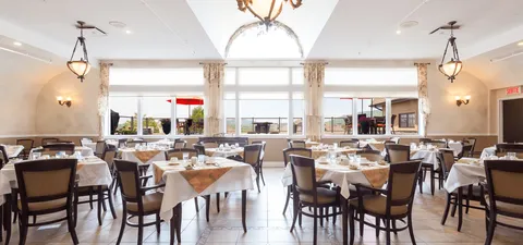 Dining room with set tables beside large windows