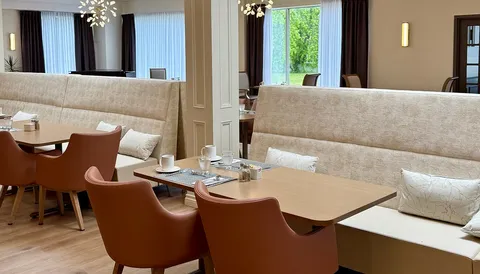 Dining booth beside large windows.