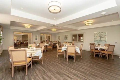 Dining room with set tables and upholstered chairs